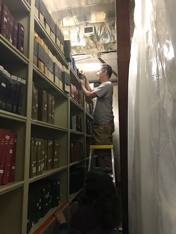 Jim looks at print journals in storage.