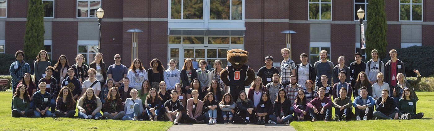 Student employees pose outside the library with Benny.